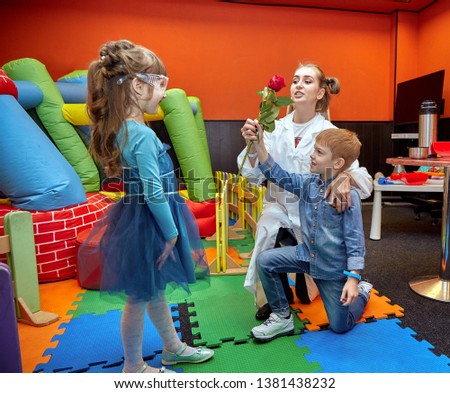 Chemical show for kids. Professor carried out chemical experiments with liquid nitrogen on Birthday little girl.