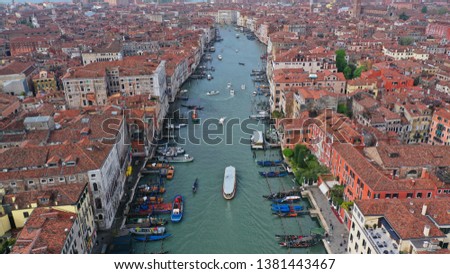 Aerial drone top view photo of iconic and unique colourful Gondolas and boats in Grand Canal near Rialto bridge, Venice, Italy