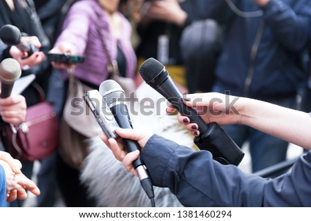 Journalists holding microphones at press conference Royalty-Free Stock Photo #1381460294