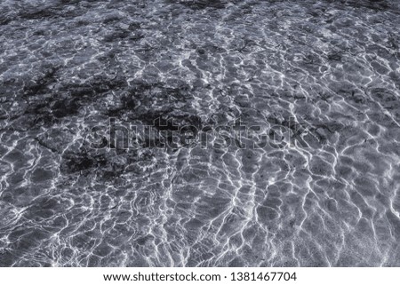 Waves on the seashore and reflected in the water