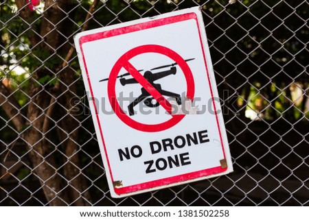 No Drone Zone, old sign on the wire mesh fence in Thai temple