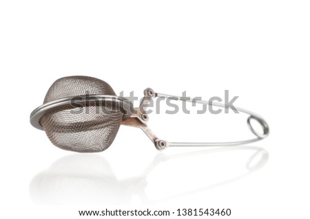 Empty old tea strainer close up on white background