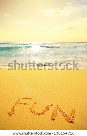 A picture of a beautiful coastline landscape and handwritten text on the sand