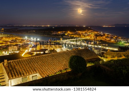 Italy Tuscany Castiglione della Pescaia, pink full moon night, panoramic night picture