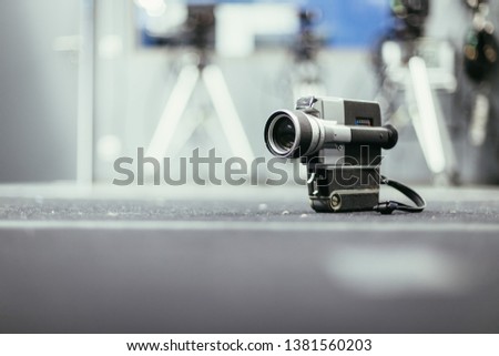 Vintage old movie camera, production studio in the blurry background