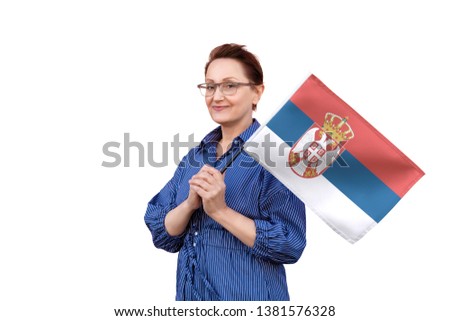 Serbia flag. Woman holding Serbian flag. Nice portrait of middle aged lady 40 50 years old holding a large flag isolated on white background.