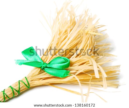 The broom with green bow on white background