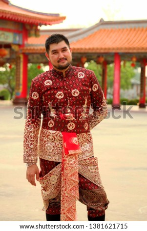 Asia man wearing typical Thai dress with Chinese Temple background identity culture at Bangkok of Thailand