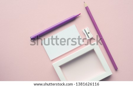 Mock up background with business cards and pencils on a pink paper backdrop