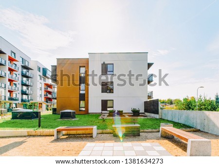 Modern residential apartment house building with outdoor facilities concept. With benches