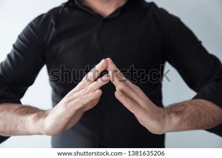 young man making  yoga with hands