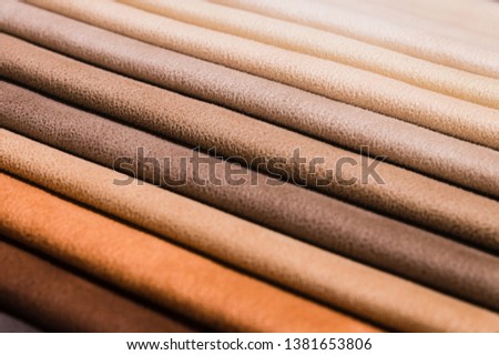 Close-up diagonal lines of textile upholstery in samples to select the color and fabric of the furniture. Abstract multicolored background