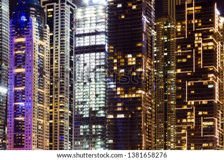 Close-up view of some modern skyscrapers and towers illuminated at night. Dubai Marina, Dubai, United Arab Emirates, UEA.