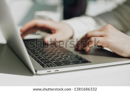 Lifestyle education student. Businessman work on laptop for project. Millennial at home office looking for job on notebook. Unrecognizable man using modern portable computer. Royalty-Free Stock Photo #1381686332