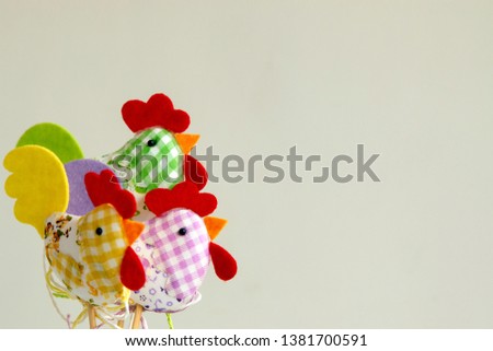 Chicken plushie doll isolated on white background with shadow reflection. Rooster plush stuffed puppet on white backdrop. Cute rainbow colored stuffed bird toy.