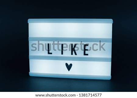 Photo of a light box with text, LIKE, isolated background