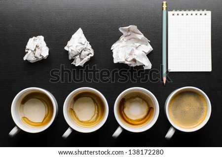 business creativity concept. empty and full cups of fresh espresso with crumple wads on desk Royalty-Free Stock Photo #138172280
