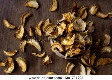 Homemade dried apples on wooden table, top view.