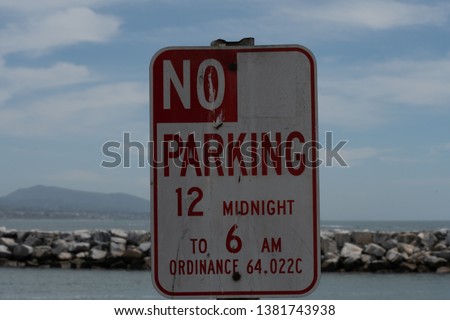 A no parking sign stating hours in effect