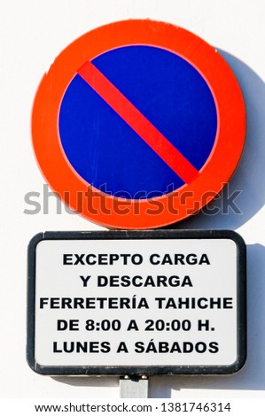 Traffic sign in a Spanish town warning motorists not to park, with the exception of loading and unloading during certain times