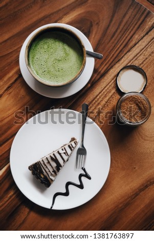 Raw vegan cake, banoffee pie on white plate, dairy free, gluten free, sugar free, no-bake. Matcha latte. Food photography, top view