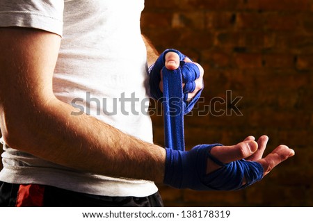 mma fighter is getting ready against brick wall Royalty-Free Stock Photo #138178319