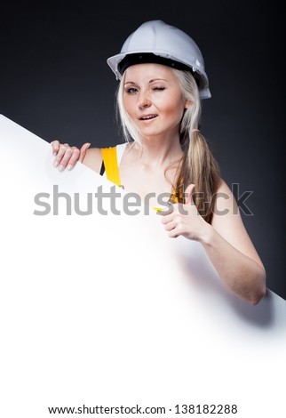 Young architect woman construction worker and empty poster