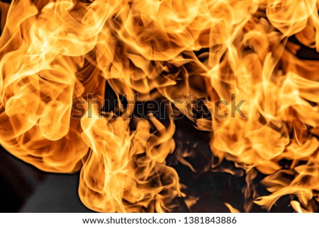 Fire flames on black background, abstract blaze.