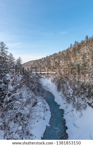 Beautiful outdoor nature landscape with shirahige waterfall and bridge in snow winter season Hokkaido Japan