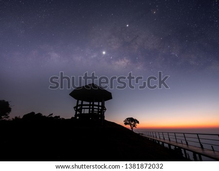 The mountain viewpoint has stars and the Milky Way in the night sky.