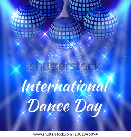 International Dance Day. Concept of the event. Mirror balls for parties with rays, blue blur background