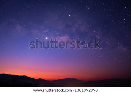 Milky Way galaxy with Jupiter Venus and Saturn over the wildfire mountain at dawn