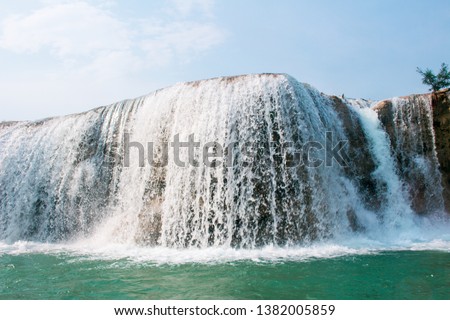 The blurry images of the river flowing from the waterfalls in Myanmar