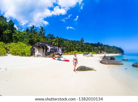 woman with a kayak on an isolated beach in Andaman sea, Koh Adang - solo travel
