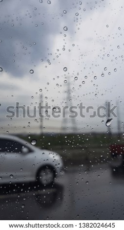 Raindrop on car window. Highway road.