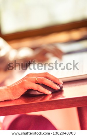 Woman working with laptop in coffee house