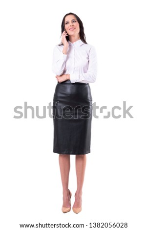 Confident happy young attractive business woman talking on the phone smiling and looking away. Full body isolated on white background. 