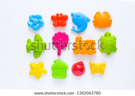 Toys for sand. Children's toy summer sea game. Multicolored plastic mold. White background. Flat lay. Rainbow color. Kindergarten playground on outdoor Royalty-Free Stock Photo #1382063780