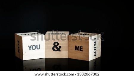 Three wooden cubes in a row - you and me