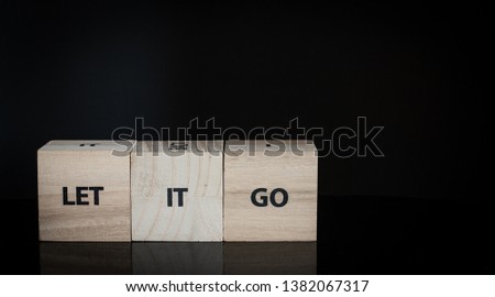 Three wooden cubes in a row - let it go