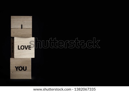Pile with three wooden cubes - I love you
