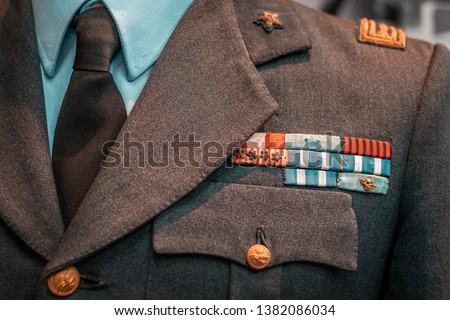 Details of historical Italian military uniforms. Grades and patches on high quality fabrics. Vintage style suits, European taste for elegance.  Royalty-Free Stock Photo #1382086034