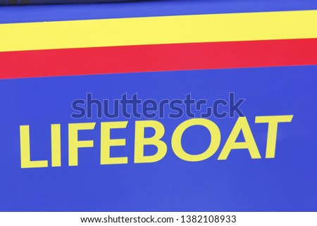 LIFE BOAT lettering on blue boat hull with strong colours