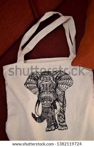 An Indian lady's bag with a picture of elephant on front 