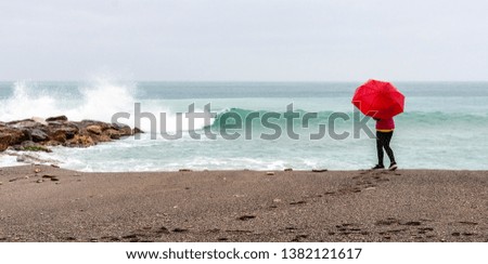 woman in front of the sea with umbrella