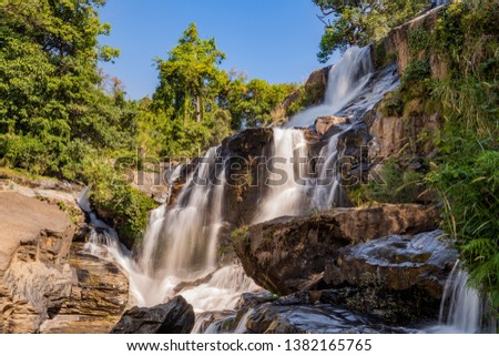Scenic cascade of Bolaven plateau waterfall, strong water flow, travel Laos