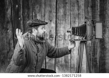 Selfie of old fashioned man on large format camera. Idea- selfie