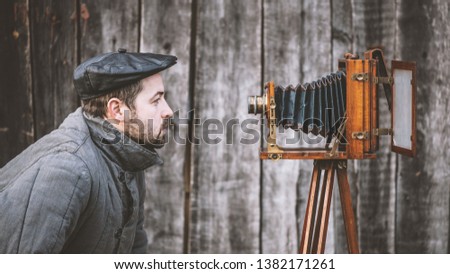 Selfie of old fashioned man on large format camera. Idea - self-portrait