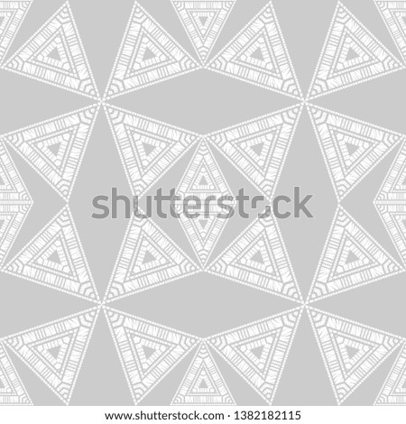Ethnic boho seamless pattern. Triangles. Embroidery on fabric. Patchwork texture. Weaving. Traditional ornament. Tribal pattern. Folk motif. Can be used for wallpaper, textile, invitation card.
