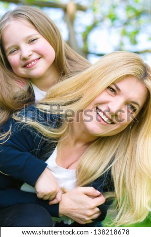Bright picture of hugging mother and daughter